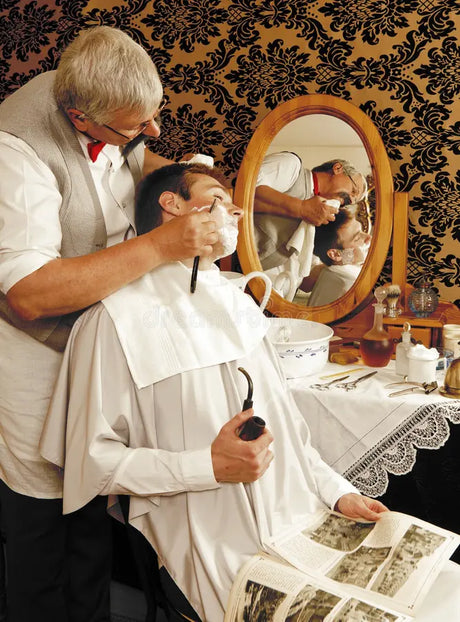 A close-up shot of a barber applying shaving cream to a client's face, highlighting traditional grooming practices.
