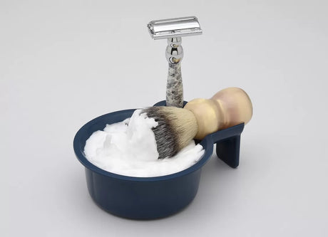a traditional shaving bowl, brush, and razor ready for lathering. Perfect for visually complementing your discussion of bowl, face, and hand lathering techniques.